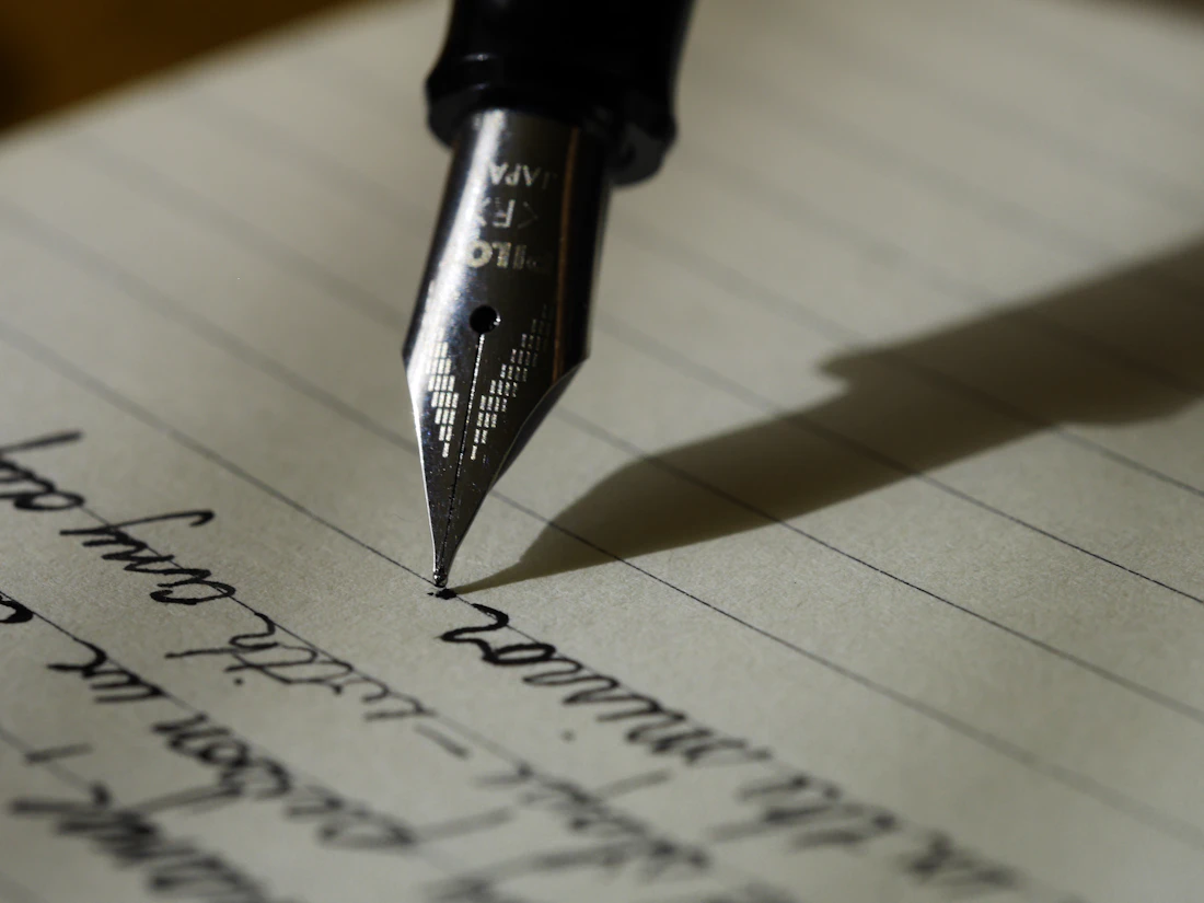 Copywriter drafting advertising headlines and descriptions at a workspace