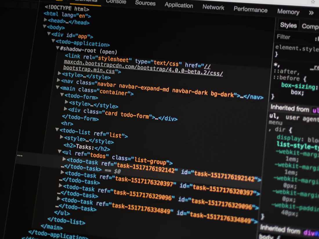 Developer building a responsive website front-end on a laptop