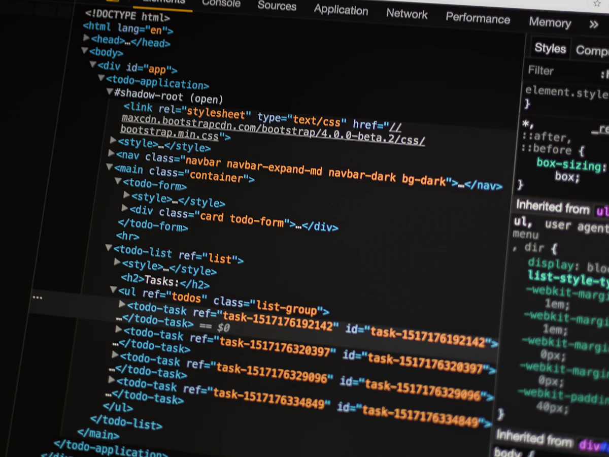 Freelance web designer building a responsive website front-end on a laptop