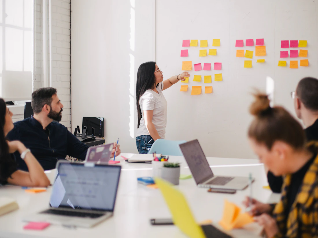 Marketing strategy session mapping paid channel selection and audience targeting on a whiteboard