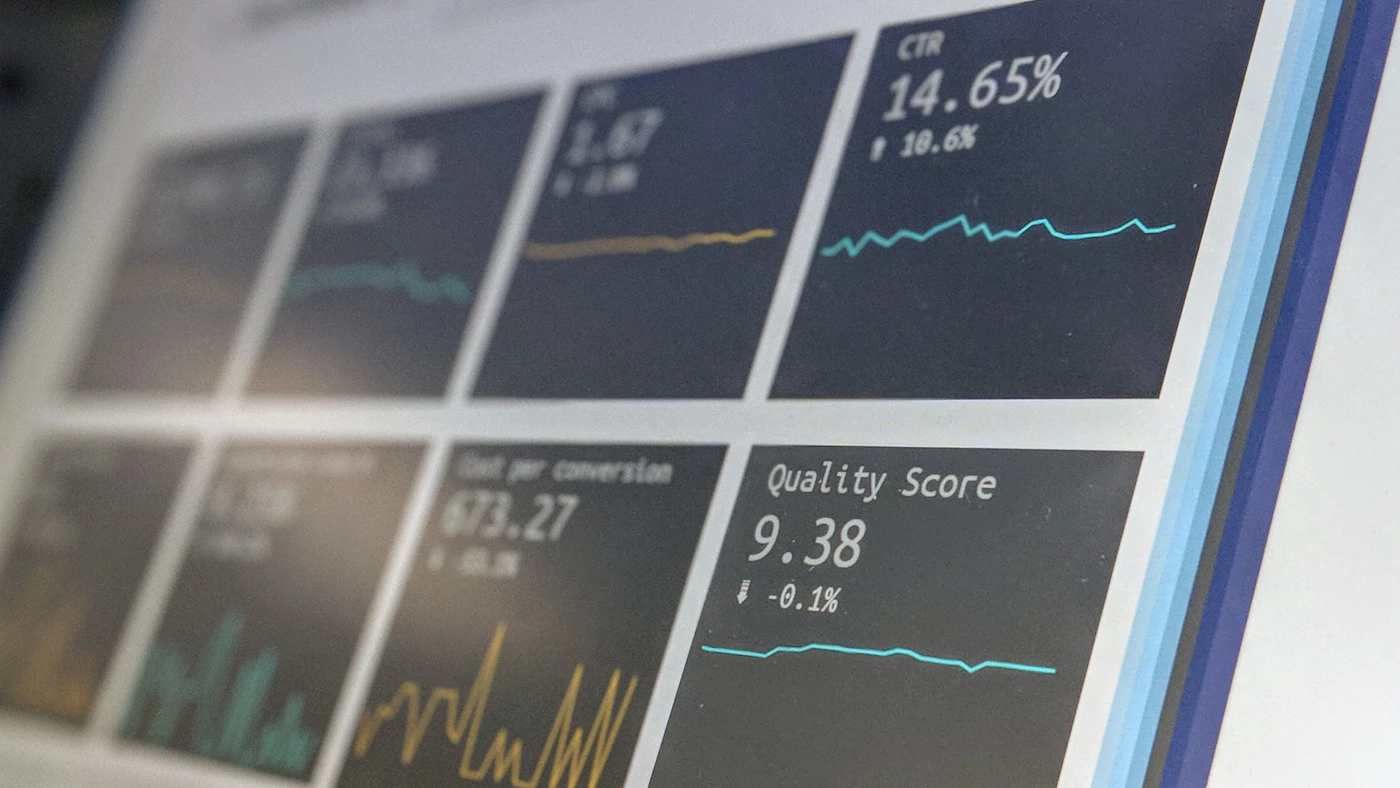 Search and visibility performance dashboards displayed across office monitors