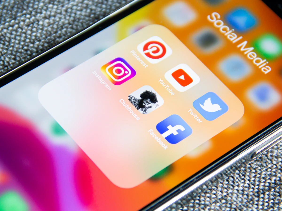 Social media advertising creative being reviewed on a phone and laptop