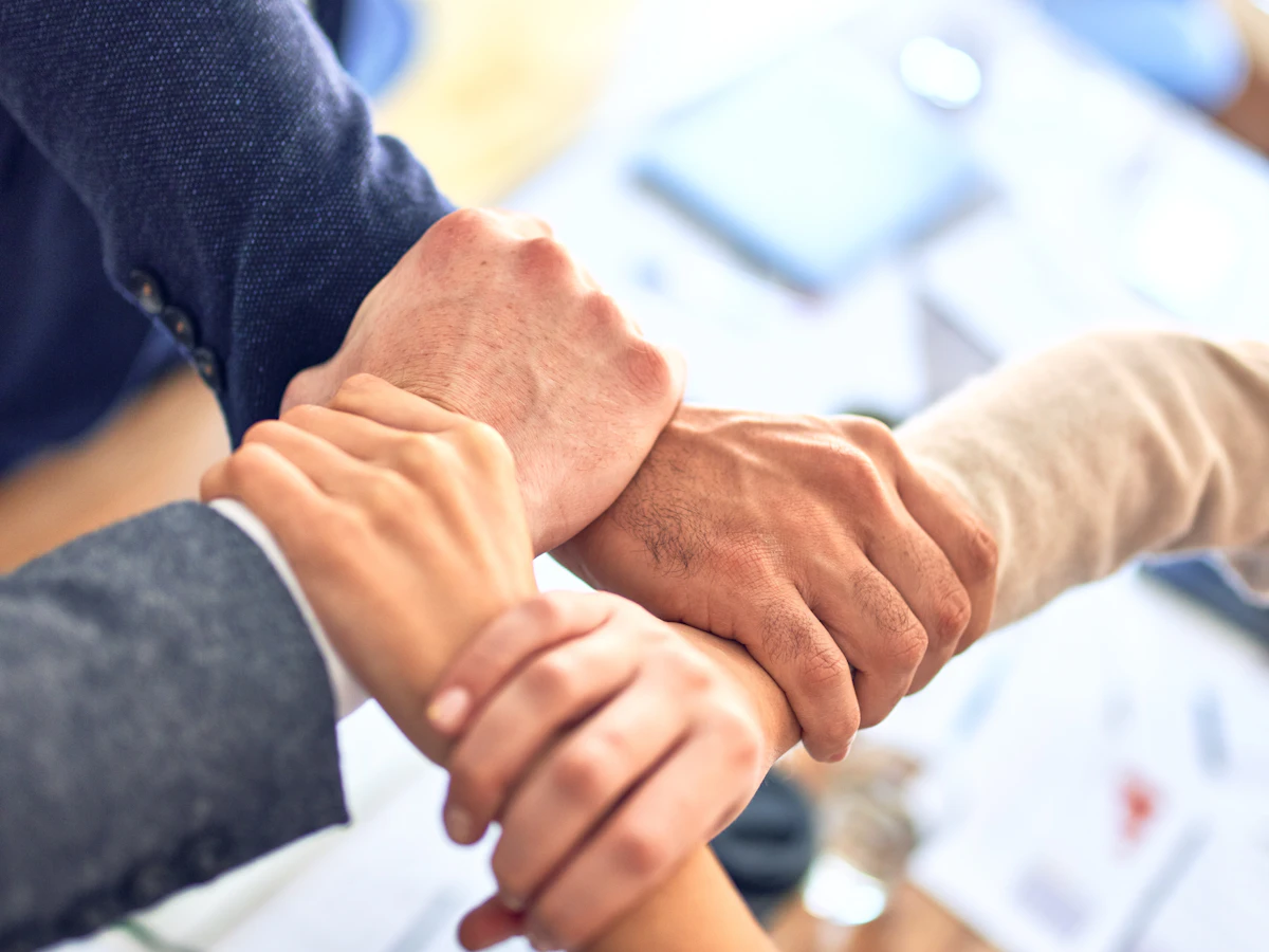 Two professionals shaking hands after a lead converts into a closed business deal